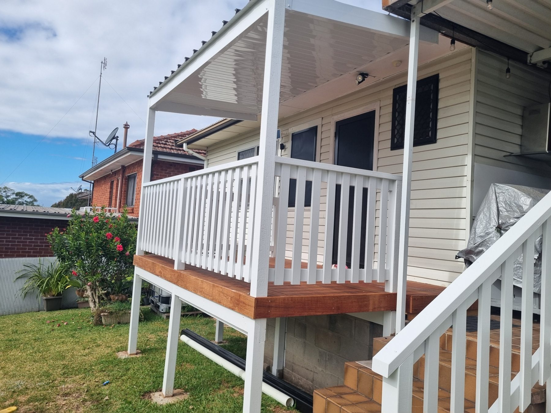 Raised deck with white railings and stairs